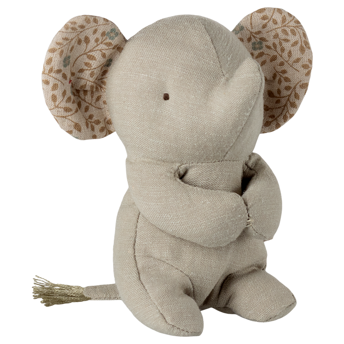 A beige fabric elephant toy with stitched eyes sits against a white background. Its large ears have a leaf pattern, creating a soft and cozy feel.