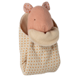 A soft pink fabric mouse peeks out of a cozy, polka-dotted sleeping bag with an orange and cream color scheme on a white background.