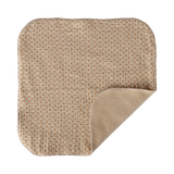 A soft, square baby blanket with rounded corners, featuring an orange polka dot pattern on a beige background. One corner is folded to reveal a plain beige underside.