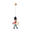 A hanging ornament of a toy soldier wearing a tall black hat, red jacket, and blue pants, playing a drum. The toy is suspended by a string, conveying a playful and cheerful tone.