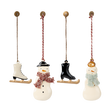 Three charming holiday ornaments: a snowman with a red scarf, an ice skate, and a snowwoman wearing a green scarf, all hanging.