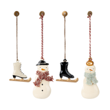 Three charming holiday ornaments: a snowman with a red scarf, an ice skate, and a snowwoman wearing a green scarf, all hanging.