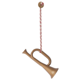 A decorative golden horn ornament hangs from a red and white twisted string, topped with a festive round button.