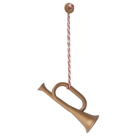 A decorative golden horn ornament hangs from a red and white twisted string, topped with a festive round button.