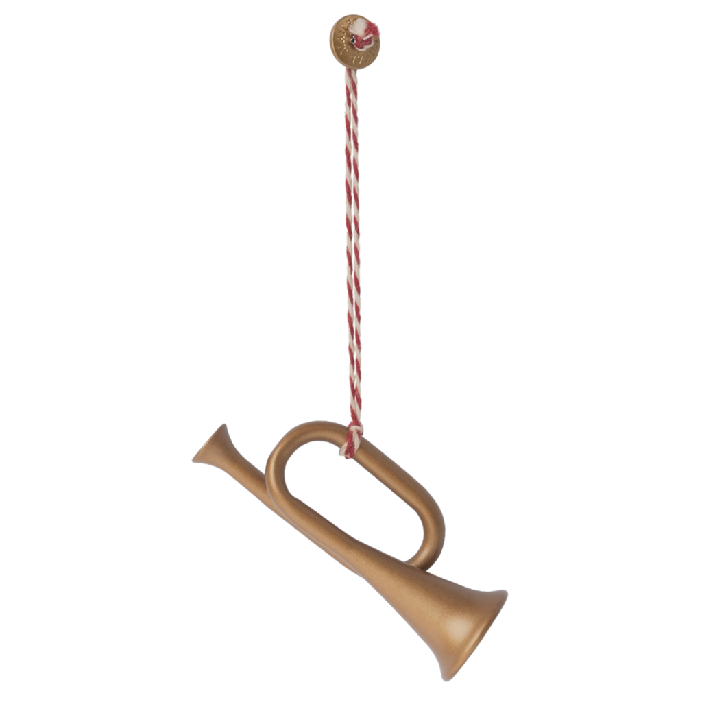 A decorative golden horn ornament hangs from a red and white twisted string, topped with a festive round button.