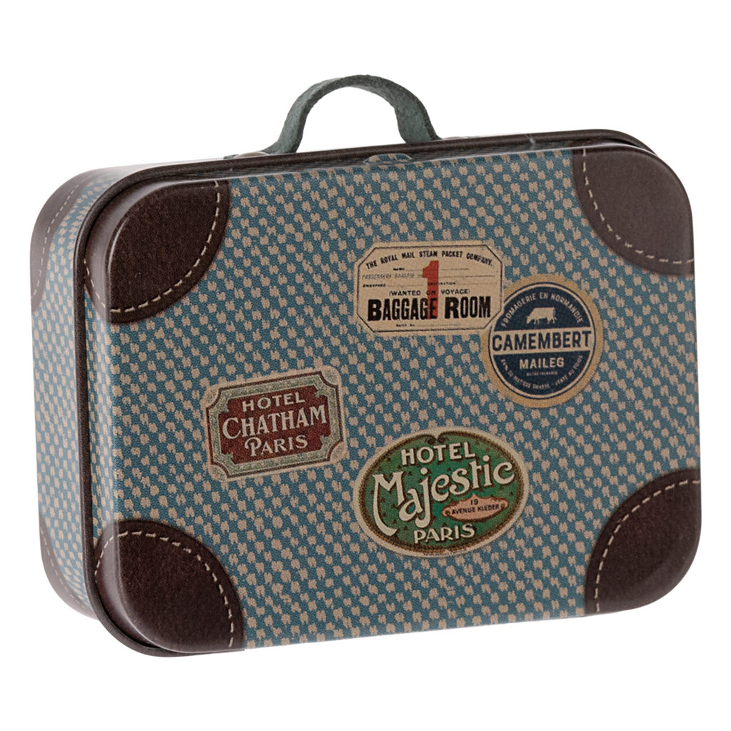 Vintage-style suitcase with blue houndstooth pattern and travel stickers, including "Hotel Majestic Paris." The design evokes nostalgia and adventure.