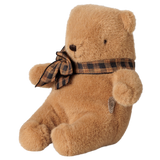 Maileg mini teddy bear plush in mushroom brown with a plaid bow tie, sitting profile view.