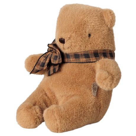 Maileg mini teddy bear plush in mushroom brown with a plaid bow tie, sitting profile view.