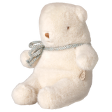 Maileg mini teddy bear plush toy in off-white sitting in a side profile view with a ribbon bow.