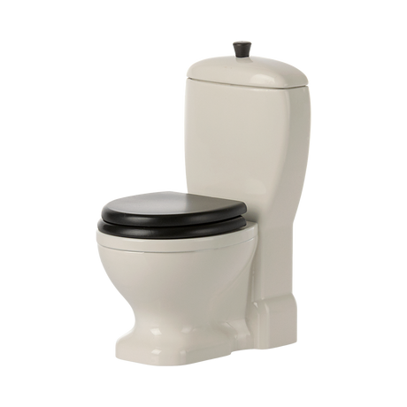 A detailed white dollhouse toilet with realistic features and movable lid—perfect for Maileg mice, bunnies, and dollhouse bathroom setups to inspire imaginative play.