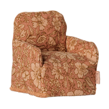 Maileg miniature dollhouse armchair in a pink floral pattern fabric.