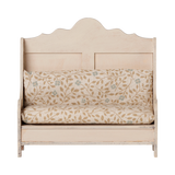 Maileg dollhouse miniature wooden kitchen bench in light sand with a floral patterned cushion.