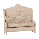 Maileg miniature kitchen bench in light sand with floral pattern cushions.