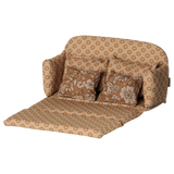 Maileg mouse dollhouse large sofa bed in ocher, unfolded open with floral pillows.