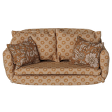 Maileg miniature dollhouse sofa bed in ocher with floral patterned pillows.