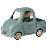Maileg mouse toy truck in mint green with a plush mouse driver, vintage metal vehicle.