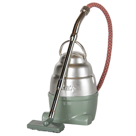 Maileg miniature toy vacuum cleaner in dark mint and silver with a red patterned hose.