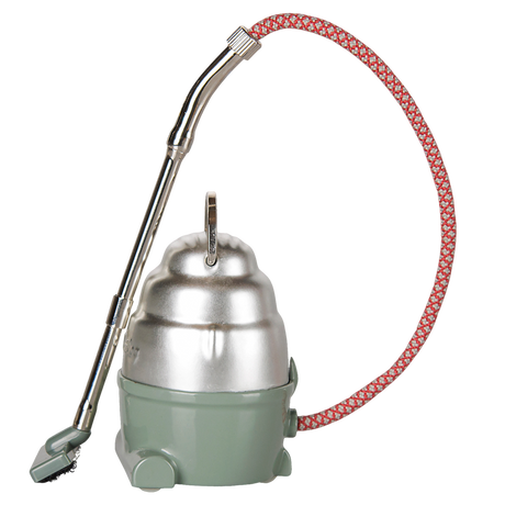 Maileg dollhouse miniature vacuum cleaner toy in dark mint green and silver with a red patterned hose.