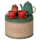 Maileg Christmas tea party set with a green teapot, red teacups, and a bundt cake on a decorative box.