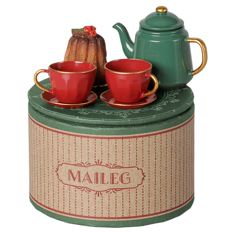 Maileg Christmas tea party set with a green teapot, red teacups, and a bundt cake on a decorative box.