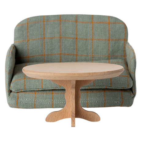 A miniature, oval wooden table with a smooth top and a decorative, carved pedestal base, showcasing a natural wood finish.