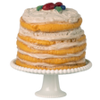 A tall, layered cake with textured icing stands on a white pedestal. Topped with colorful decorative fruits, it sits against a white background.