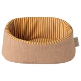 A cozy, rounded beige pet bed with a visible label on the side. The interior features yellow and white vertical stripes, creating a warm, inviting look.