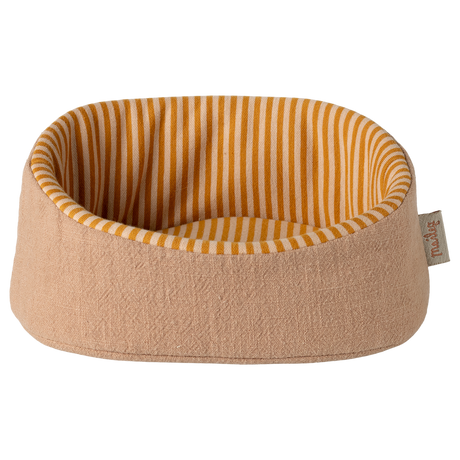 A cozy, rounded beige pet bed with a visible label on the side. The interior features yellow and white vertical stripes, creating a warm, inviting look.