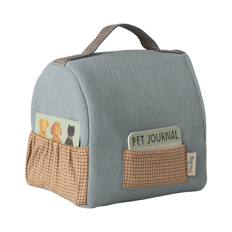 Soft fabric case with a gray handle and brown pockets, containing a pet journal and a card with animal illustrations, set against a white background.