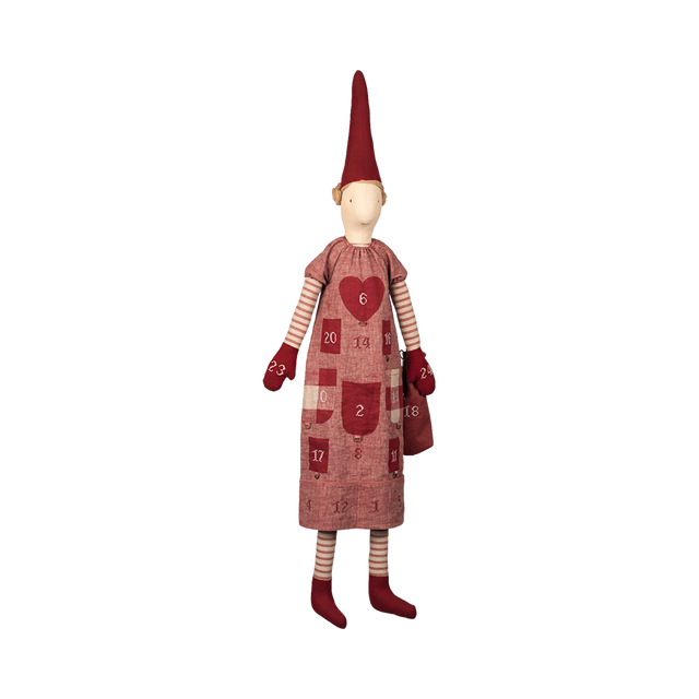 A whimsical doll with a tall red hat and striped leggings wears an advent calendar dress with numbered pockets and a heart design, creating a festive, joyful tone.