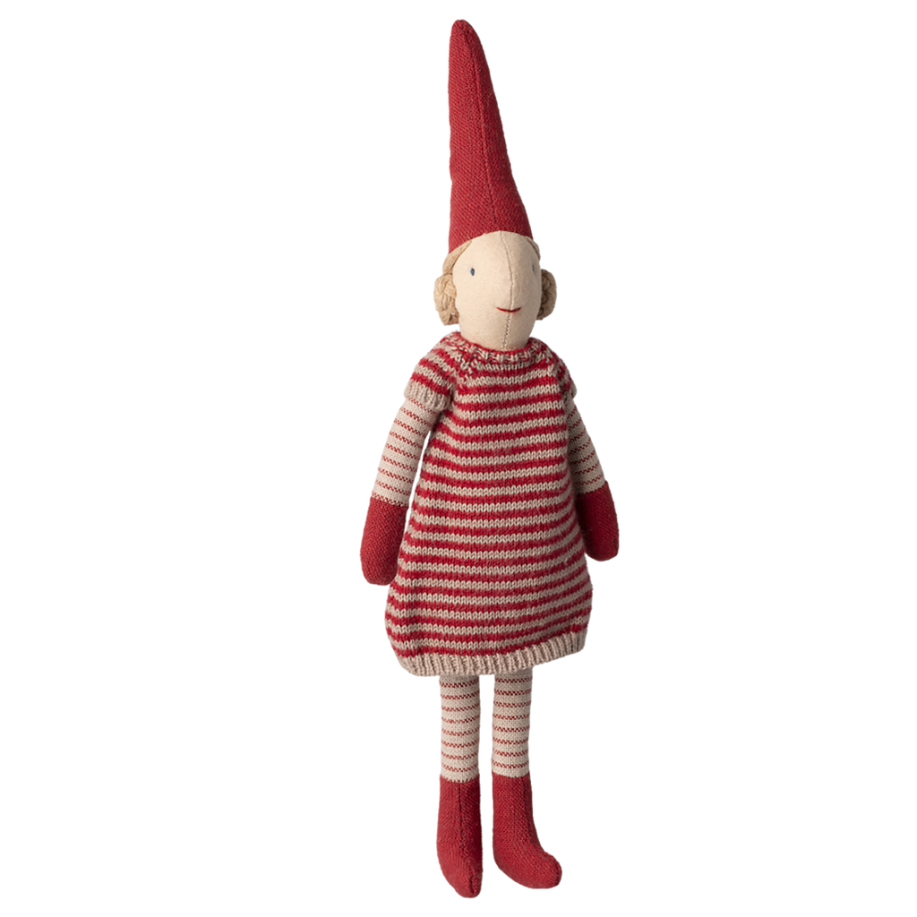 A whimsical elf doll with a red pointed hat and striped red and white outfit stands against a white background, conveying a cheerful tone.