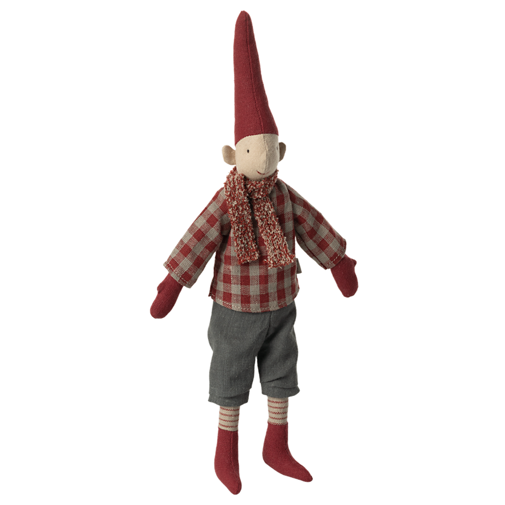 A whimsical elf doll against a white background, wearing a red plaid shirt, gray pants, a knit scarf, and a tall red hat, exuding a cheerful vibe.