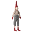 A whimsical doll with a tall red hat, red mittens, and socks. It wears a beige shirt and gray pants with a friendly, inviting expression.