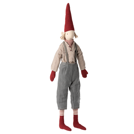 A whimsical doll with a tall red hat, red mittens, and socks. It wears a beige shirt and gray pants with a friendly, inviting expression.