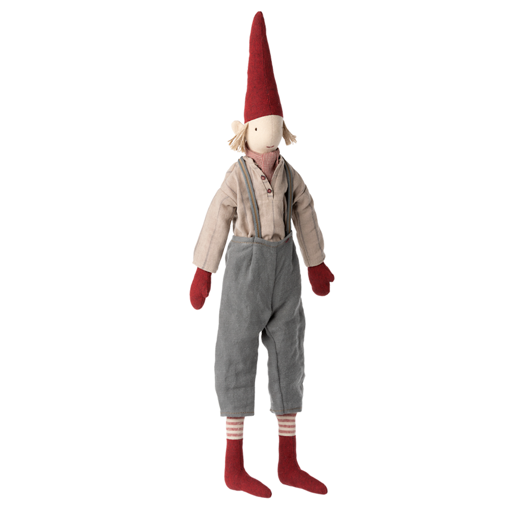 A whimsical doll with a tall red hat, red mittens, and socks. It wears a beige shirt and gray pants with a friendly, inviting expression.