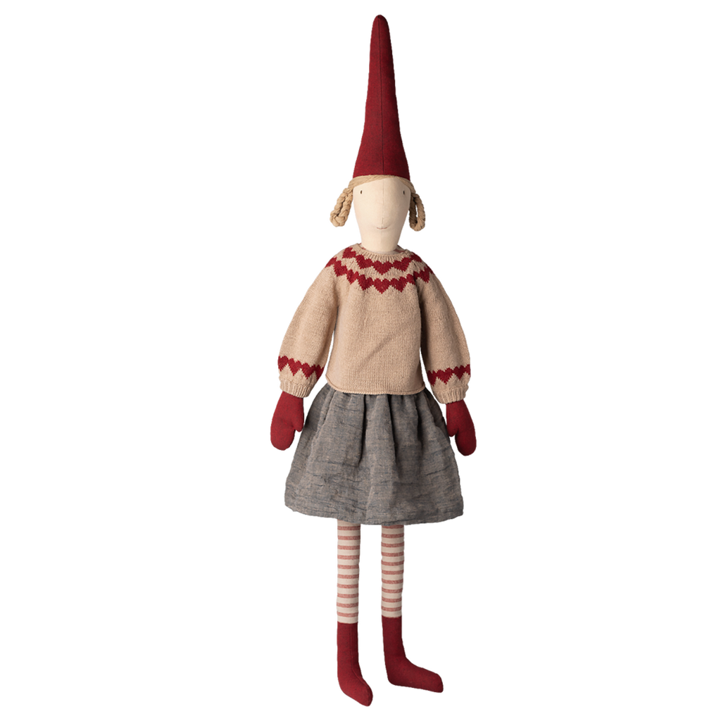 Whimsical doll with a tall red hat, beige sweater with red details, gray skirt, red mittens, and striped leggings, set against a white background.