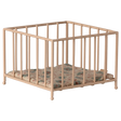 A small, beige metal playpen with a colorful, quilted cushion sits empty against a white background, conveying a sense of simplicity and nostalgia.