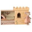 Toy set depicting "The Princess and the Pea" with a plush mouse in a patterned dress beside a castle box. Inside, layered mattresses are under a chandelier.