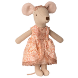 A stuffed toy mouse wearing a detailed pink patterned dress with glittery trim. The mouse's large ears and cute appearance convey a playful tone.