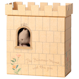 A cardboard castle with a toy mouse peeking through a window. The castle is beige with decorative flowers and the text "The Princess Mouse and the Pea."