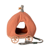 Fabric toy shaped like an orange pumpkin carriage with four wooden wheels and a floral-patterned pull string, creating a whimsical, fairy-tale feel.