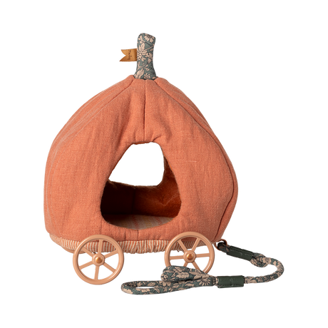 Fabric toy shaped like an orange pumpkin carriage with four wooden wheels and a floral-patterned pull string, creating a whimsical, fairy-tale feel.