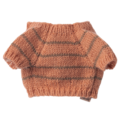 A small peach-colored, hand-knitted sweater with short sleeves and grey horizontal stripes against a white background. Cozy and handmade feel.