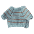 Light blue, hand-knitted doll sweater with brown stripes and short sleeves on a white background. Warm, cozy appearance reflects a handmade charm.