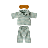 Light blue and white striped doll-sized pajamas with short-sleeved top and pants, accompanied by a small brown sleep mask. The tone is cozy and playful.