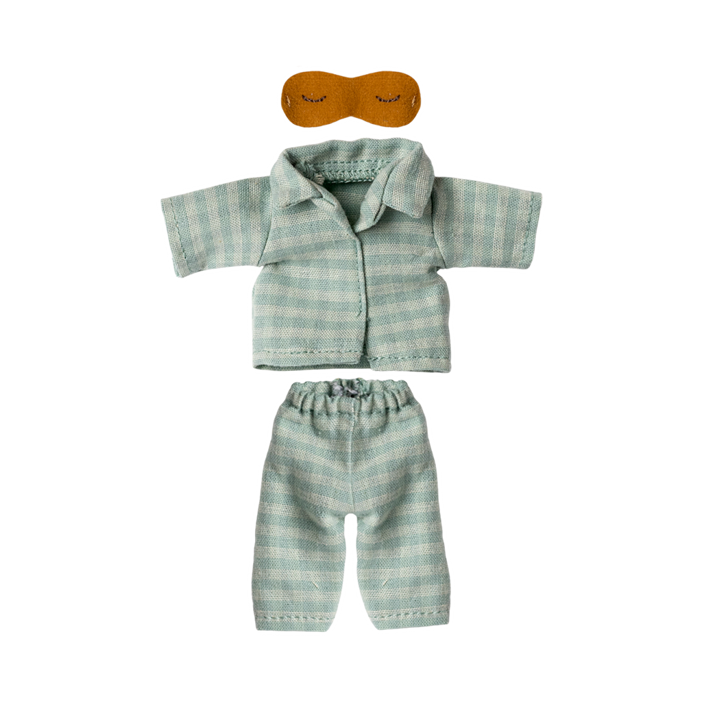 Light blue and white striped doll-sized pajamas with short-sleeved top and pants, accompanied by a small brown sleep mask. The tone is cozy and playful.