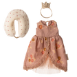 A floral pink doll dress with lace trim, a fabric crown, and a polka-dotted neck pillow are displayed on a white background. Elegant and playful.