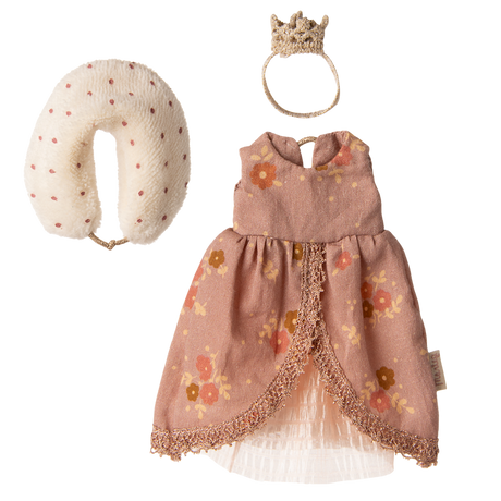 A floral pink doll dress with lace trim, a fabric crown, and a polka-dotted neck pillow are displayed on a white background. Elegant and playful.