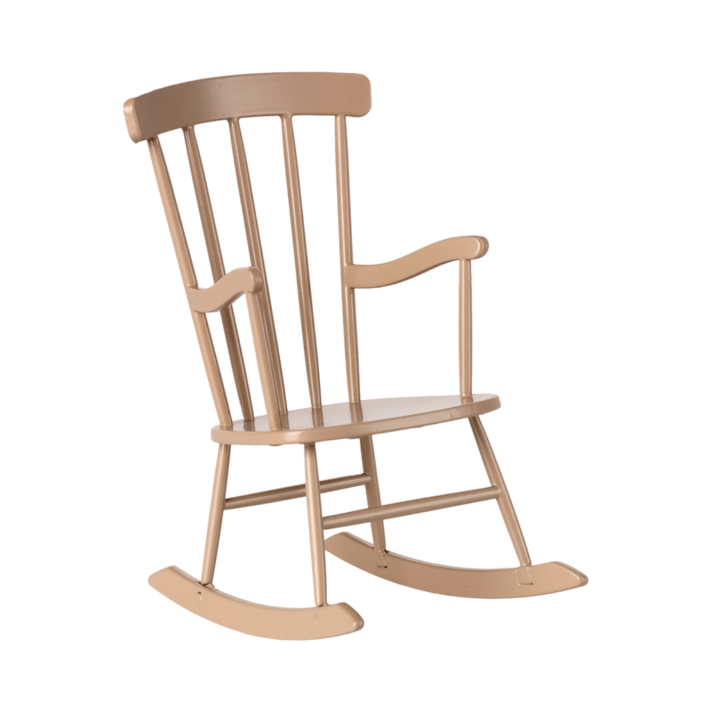 A light brown miniature wooden rocking chair with vertical slats on the backrest and curved armrests. It sits in a minimalist style on a white background.