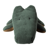 Green plush crocodile toy with simple black eyes and brown underside, set against a white background. It has a soft, friendly appearance.